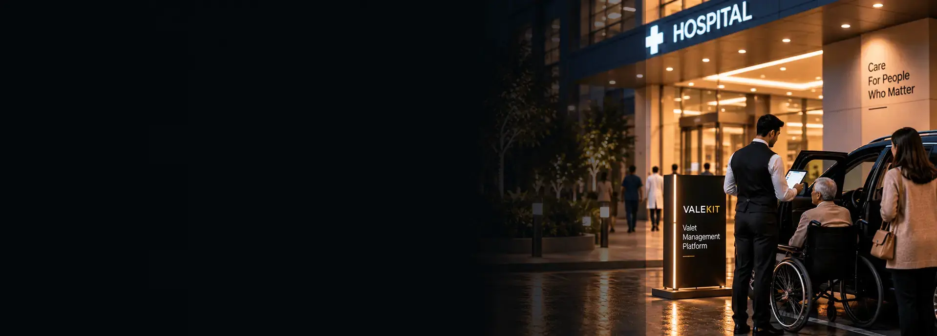 Valet attendant using ValeKit hospital valet parking software on a tablet outside a hospital entrance at night