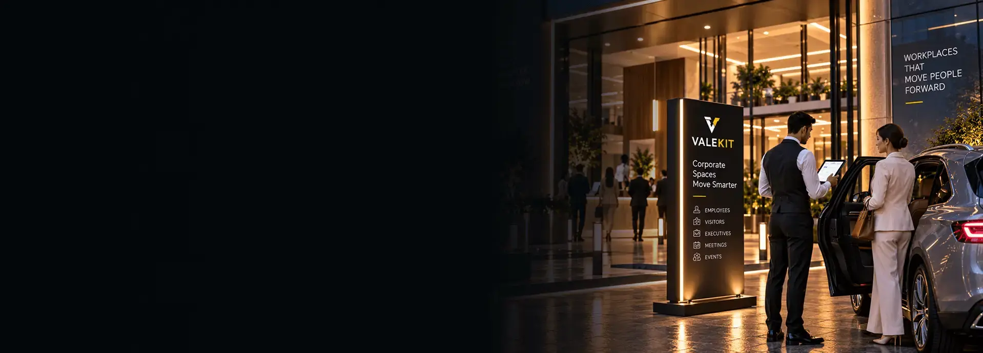 Valet attendant using ValeKit corporate valet parking software on a tablet at an office building entrance at night