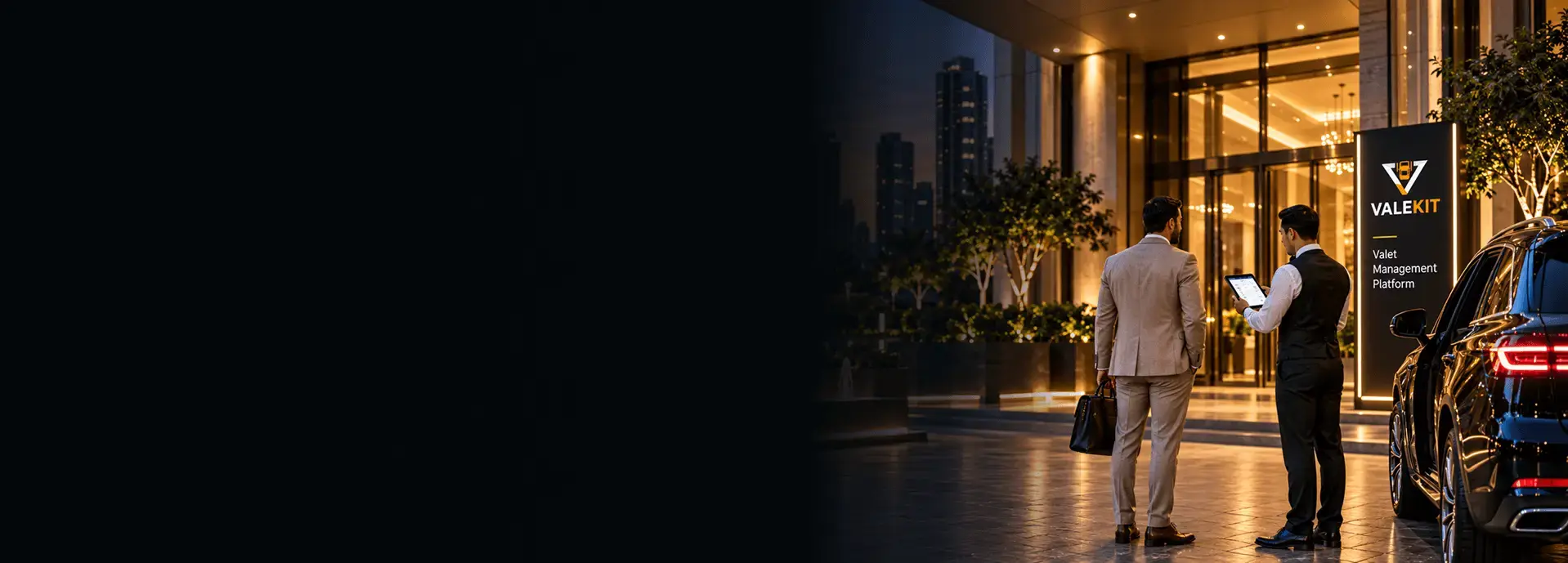Valet attendant using ValeKit residential valet parking software on a tablet at a luxury residential tower entrance at night